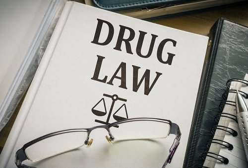drug law book with pair of eyeglasses on top
